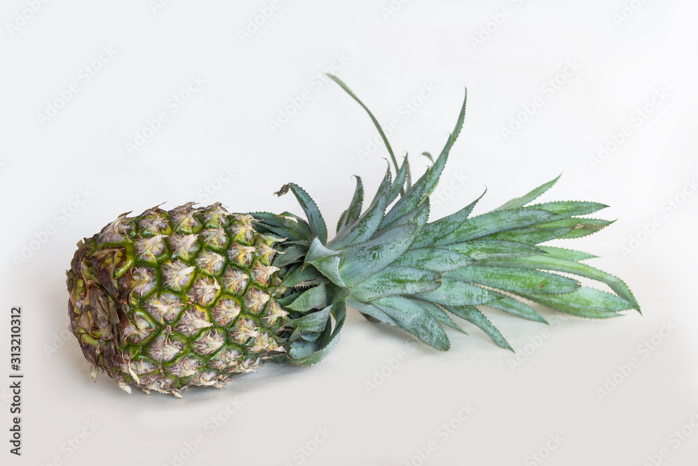 A pineapple stands alone on a white background.