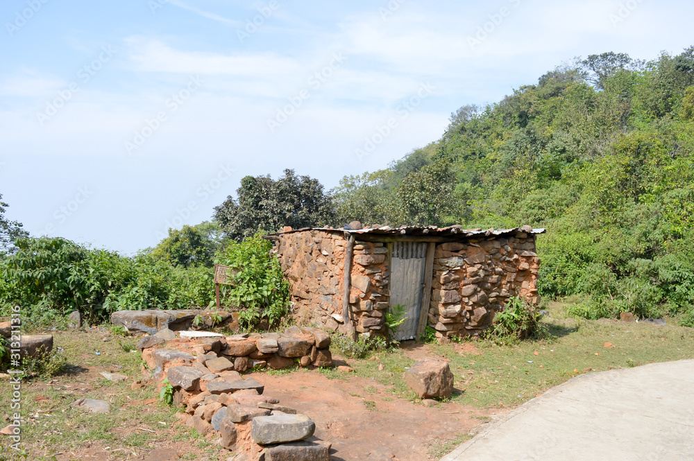 An old ruin abandoned house in mountain forest. Damaged broken demolished ruined fortified brick wall building exterior. Architecture nature landscape background. Travel tourism concept. Sikkim India.