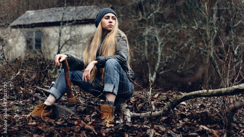 Attractive Girl Resting In Forest Holds An Ax In Hands. Bushcraft Survival Concept