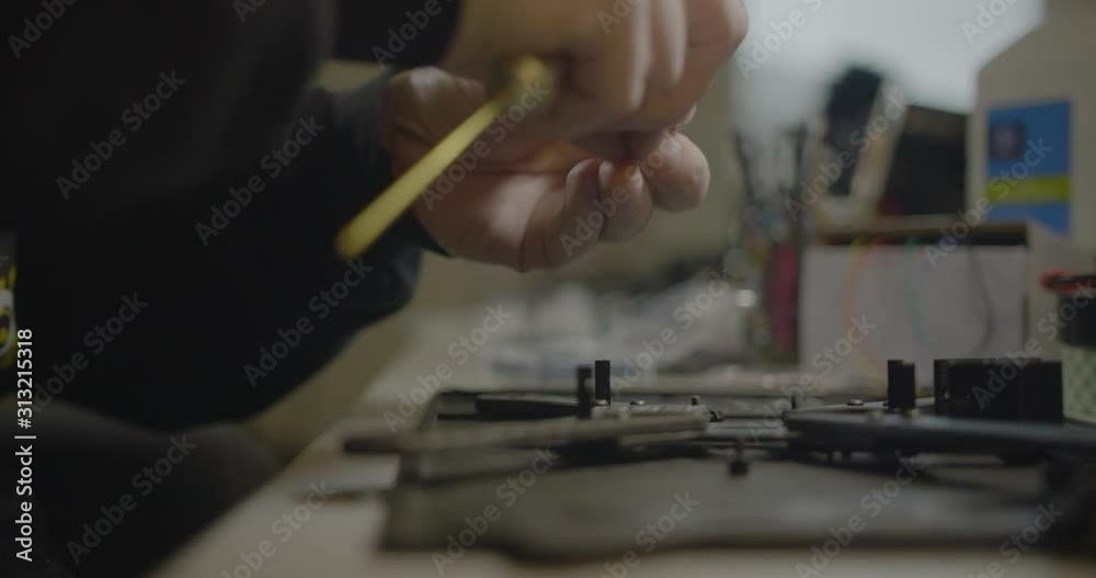 Factory worker assembling and inspecting product. Factory worker assembling and inspecting product.