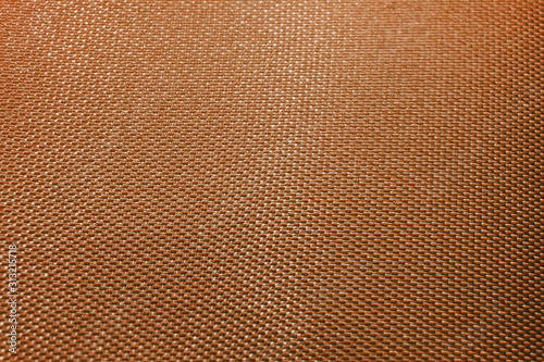 Close-up abstract flat orange high detail textured clothing fabric pattern background partial focus and realistic light