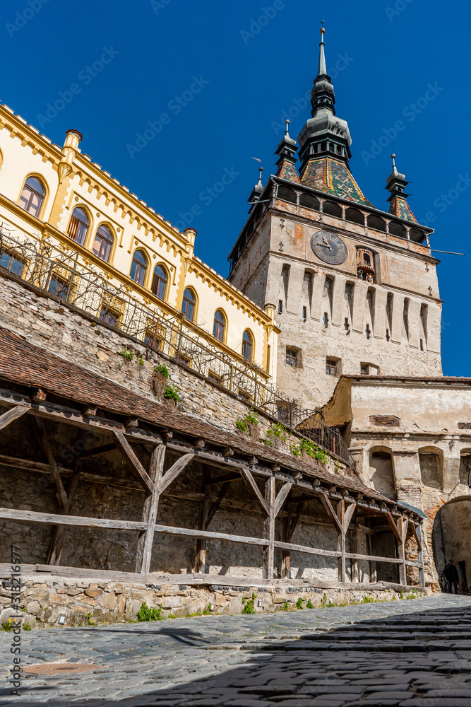 The clock tower in old town of Sighisoara  afternoon during spring season . One of the most impotant tower . Also Sighisoara is Unesco sites of the country , Sighisoara , Transylvania , Romania