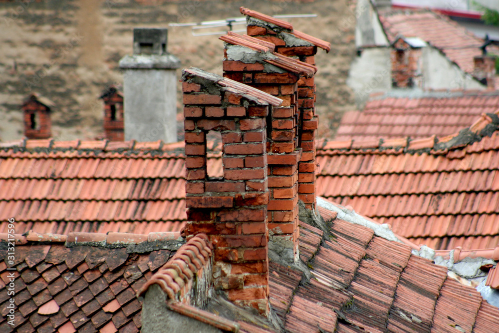 Old roof with horn and red tile on medieval city