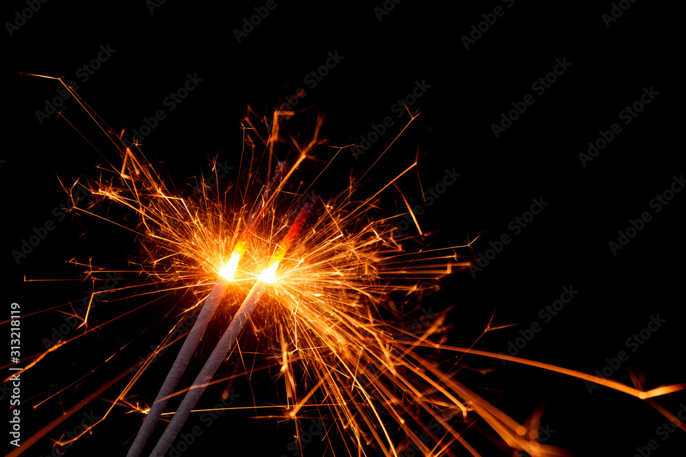 Burning firework sparklers on black background	
