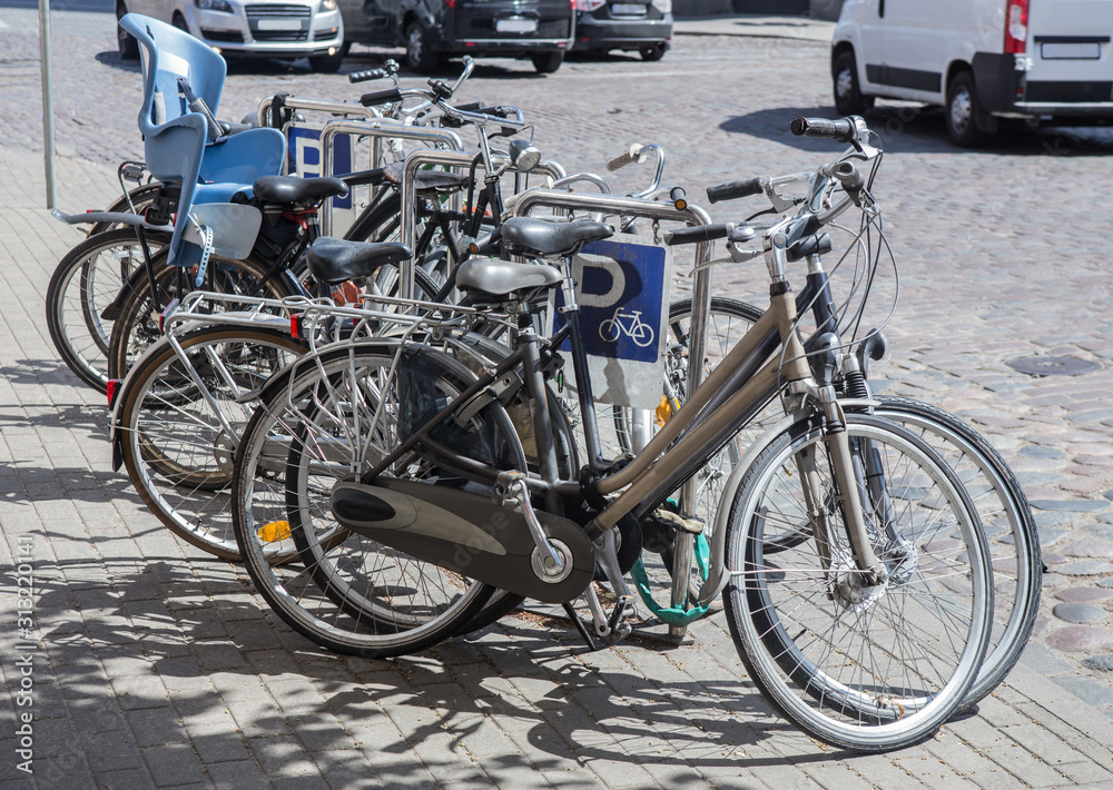 Bicycles on a bike park on the sidewalk