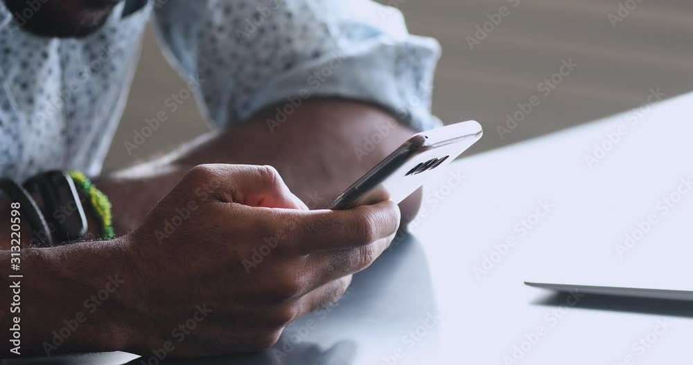 African user holding phone using mobile apps, close up view