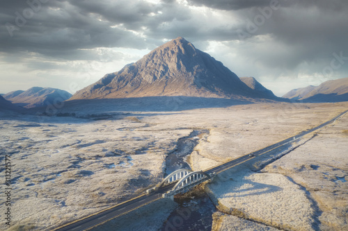 Buachaille Etive Mor in moody winter frost moor highlands landscape and road bridge at Glencoe Scotland uk photo