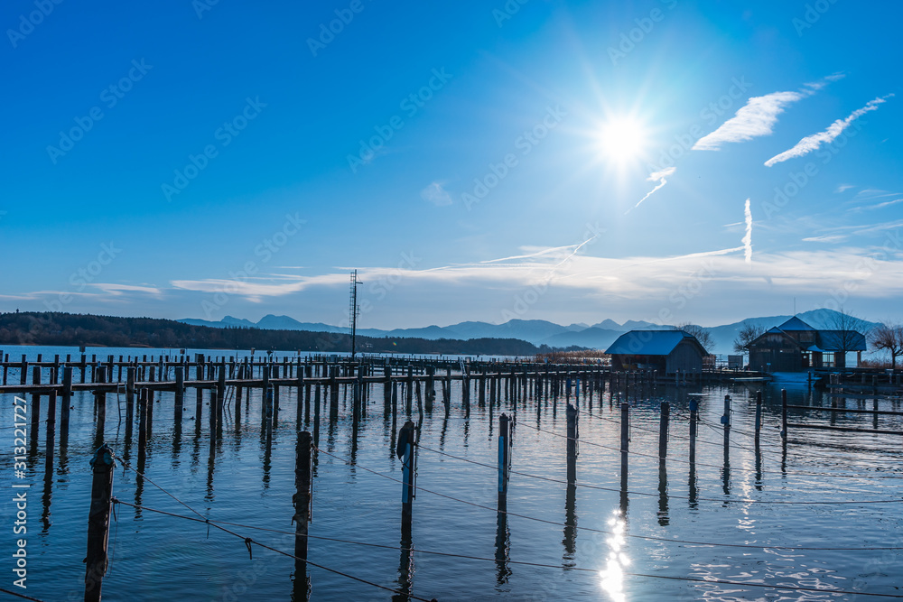 boats and fishermans on a lake at gthe pier on a bright day boats and fishermans on a lake at gthe pier on a bright day