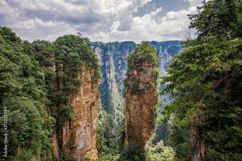Fototapeta Top view of amazing natural quartz sandstone pillars of fantastic shapes among green woods in the Tianzi Mountains Avatar Mountains, the Zhangjiajie National Forest Park, Hunan Province, China