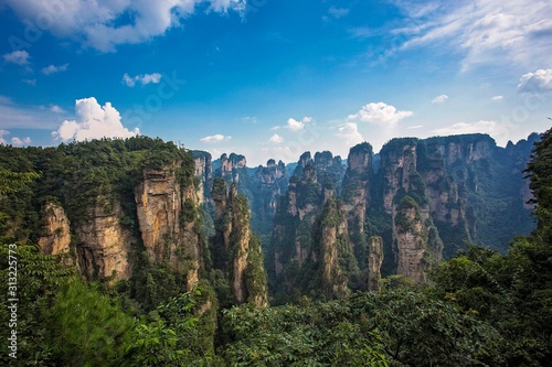  Amazing view of natural quartz sandstone pillar the Avatar Hallelujah Mountain among green woods and rocks in the Tianzi Mountains, the Zhangjiajie National Forest Park, Hunan Province, China. © liliportfolio