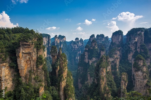Fototapet Amazing view of natural quartz sandstone pillar the Avatar Hallelujah Mountain among green woods and rocks in the Tianzi Mountains, the Zhangjiajie National Forest Park, Hunan Province, China