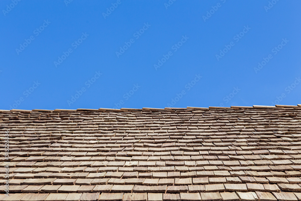 Roof and Sky. Wooden wall combines with many wooden plates. wood roof Roof and Sky. Wooden wall combines with many wooden plates. wood roof