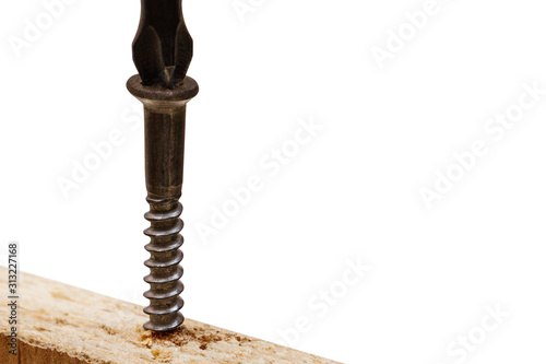 Screwing a screw into a wooden board isolated on a white background