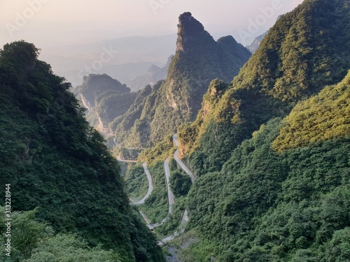 Wall Mural Tianmen Mountain Known as The Heaven`s Gate surrounded by the green forest and mist at Zhangjiagie, Hunan Province, China, Asia