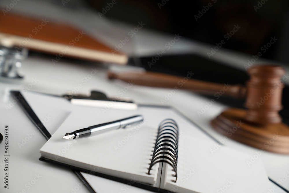 Medical law concept. Gavel, notebook and stethoscope on the white table. Place for text. Medical law concept. Gavel, notebook and stethoscope on the white table. Place for text.