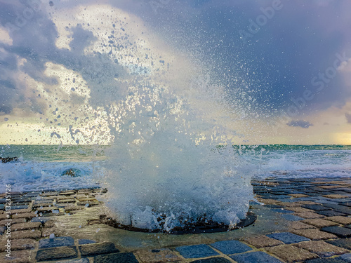 Storm at the Sea. A Water Splashes Through the Sewer Manhole.