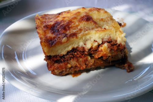 moussaka with aubergine on a dish. traditional greek meal on a table