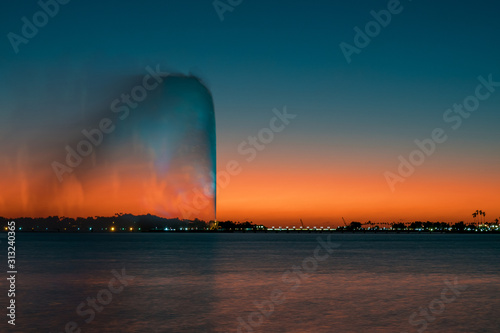 View of the King Fahd's Fountain seen from the South Corniche, Jeddah, Saudi Arabia, with a beautiful sunset in the background