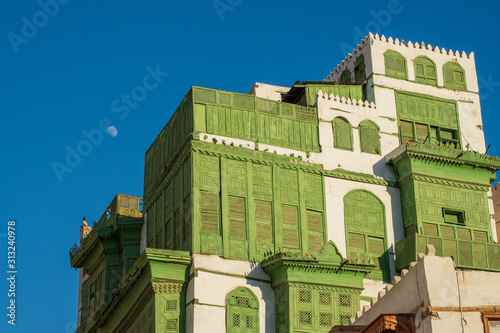 View of the famous greenish Noorwali coral town house at the Souk al Alawi Street in the historic city center of Al Balad, Jeddah, Saudi Arabia