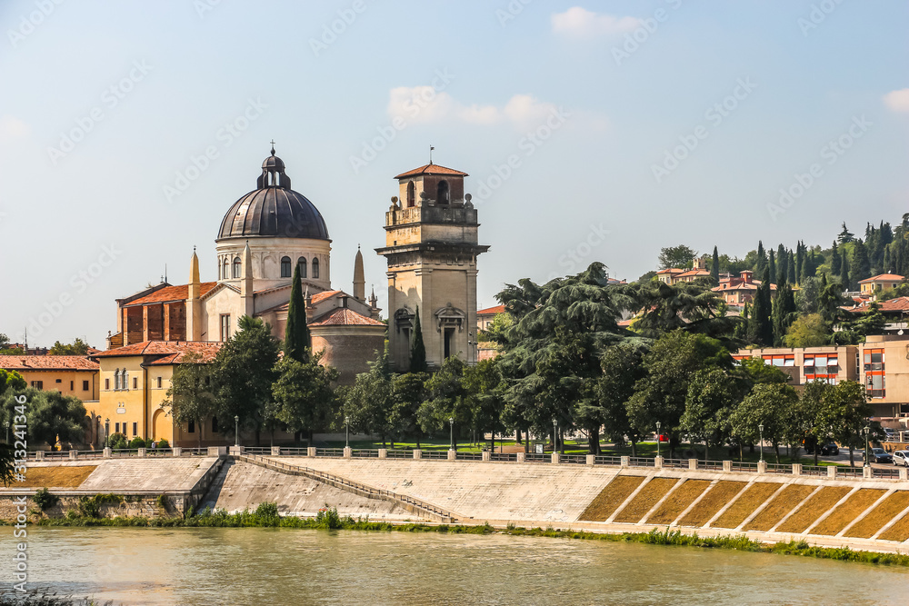 Verona, Italy. View of catholic church (Parrocchia di San Giorgio in Braida) on the riverbank of Adige river in Verona.