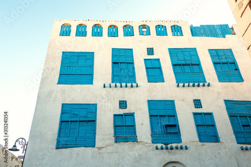 Exterior view of a recently renovated traditional residential town house in the historic district and old city Al Balad, Jeddah, Saudi Arabia photo