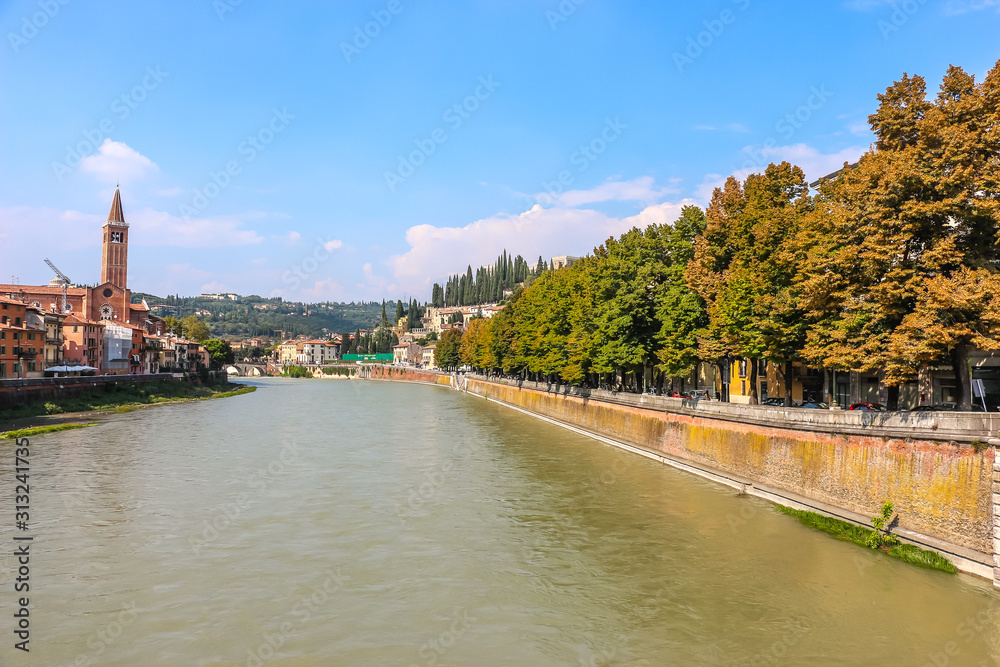 Verona, Italy. View of Adige river embankment in sunny day. Verona, Italy. View of Adige river embankment in sunny day.