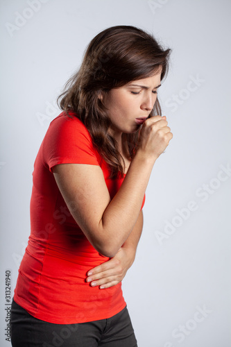 Young pretty brunette woman wearing red t shirt and coughing