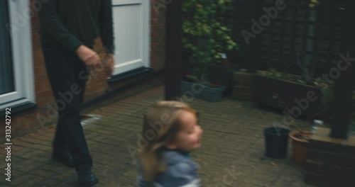 Toddler being chased around the garden by grandfather