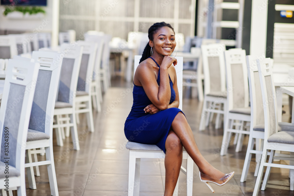 Charming african american woman posing at restaurant.
