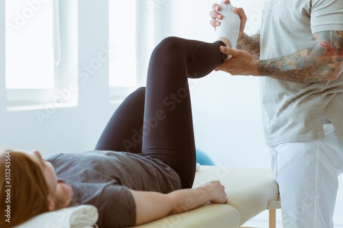 Принти на полотні Injured patient and professional physiotherapist doing muscle stretching exercis