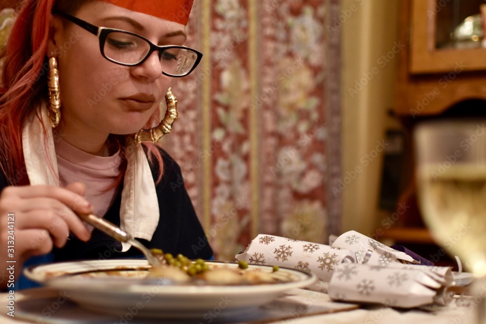 woman with a sad face eating Christmas dinner 