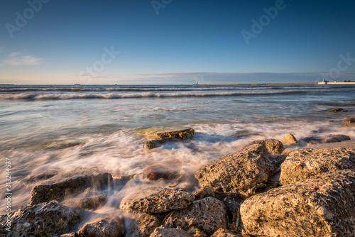 Rocky beach of the Baltic Sea at sunset light. Poland. photo