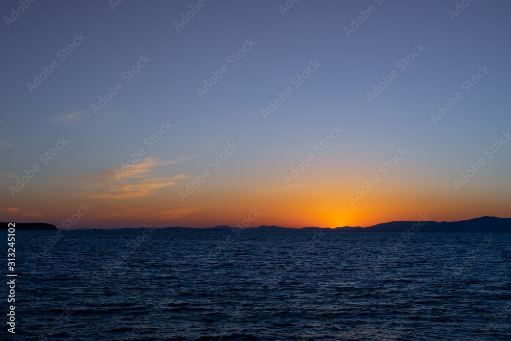 Fototapeta premium Seascape with sunset on the horizon. Vladivostok, Russia