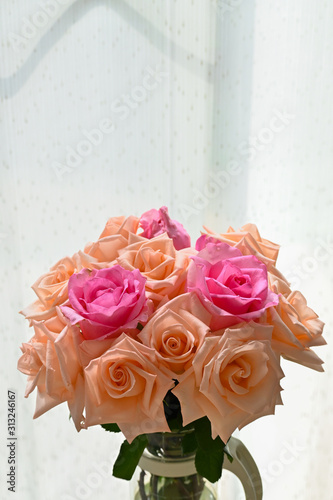 arrangement romantic bouquet orange and pink rose blossom flower in vase with sunlight in the morning day © sutichak