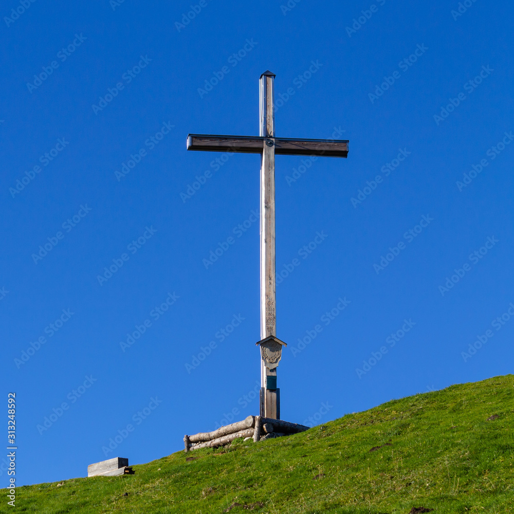 Summit Cross of Mount Rauheck, 1590 m in Bavarian Prealps, located near Ohlstadt, Upper Bavaria, Germany. Europe