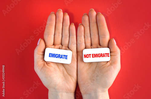 Expat and emigration idea. Emigrate or not. Concept with blocks and text in a hands.