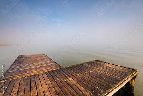 Wooden jetty by the sea during the morning fog. Baltic Sea, Sopot Poland