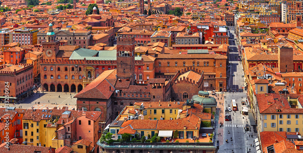 Bologna Italy. Panoramic aerial view of old town with terracotta houses and tegular roofs with central square Piazza Maggiore and main street.