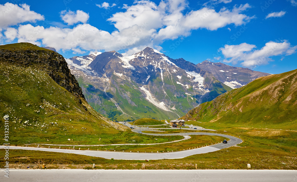 Naklejka premium Panoramic view at Pasterze Glacier Grossglockner among austrian Alps mountains summits blue sky clouds.