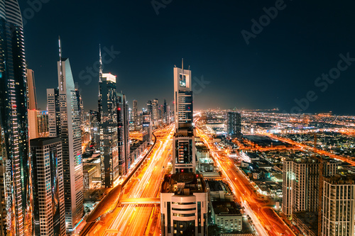 Washable wallpaper murals Night view of the spectacular landscape of Dubai  with high-rises and skyscrapers at the Sheikh Zayed highway. Global travel  destinations and real estate concept 