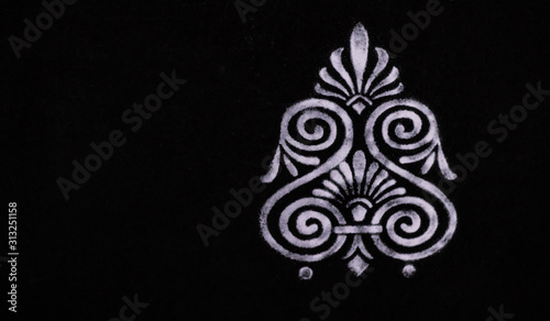 top view white color rangoli design on black background with copy space in the left side. deepawali concept
