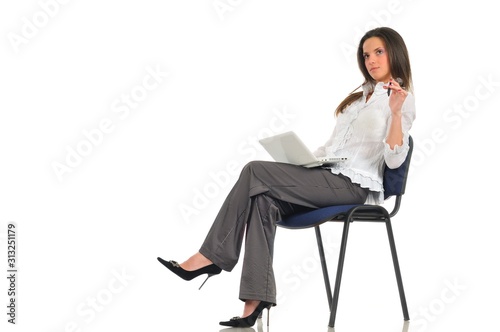 Woman sitting on chair with laptop on lap