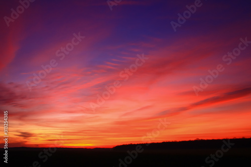 Very colorful clouds in dramatic sky. Romantic sunset at the countryside. © Bruno