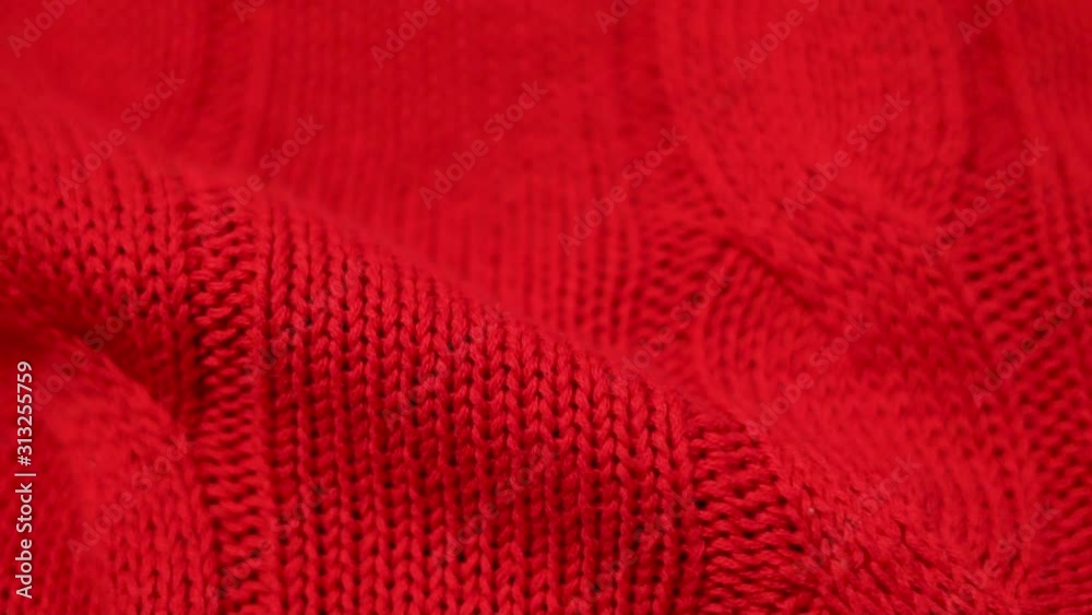 Close-up of red knitted fabric texture. Knitted texture of cozy and soft cotton plaid, textiles, clothing. Close-up of red knitted fabric texture. Knitted texture of cozy and soft cotton plaid, textiles, clothing.