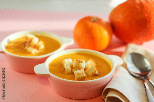 pumpkin soup puree on a pink background