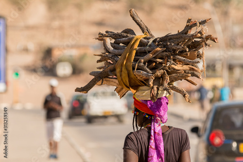  African woman carrying goods on the head.