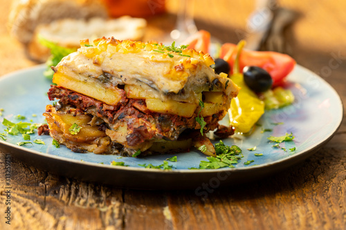 greek salad with moussaka on wood