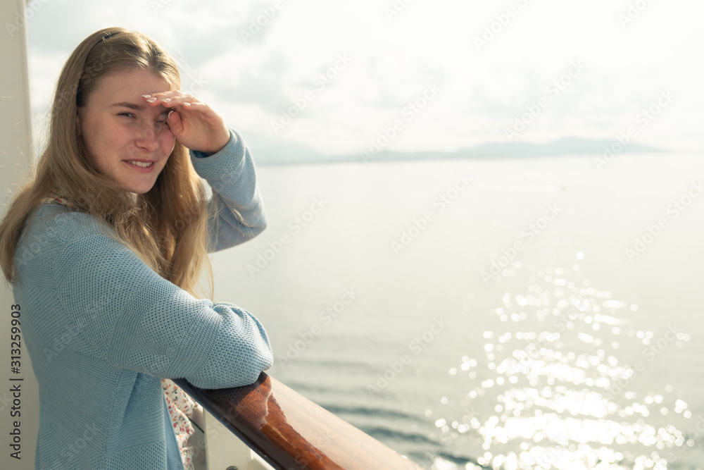 Cruise ship vacation. Teenager girl relaxing on luxury cruise ship balcony. Portrait of a happy beautiful girl on a cruise ship at sunrise Cruise ship vacation. Teenager girl relaxing on luxury cruise ship balcony. Portrait of a happy beautiful girl on a cruise ship at sunrise