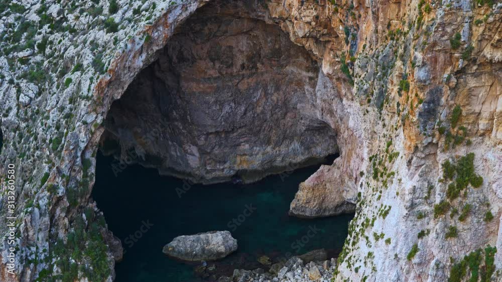 The Blue Grotto sea cavern and flock of birds, natural landmark in Malta island in the Mediterranean Sea The Blue Grotto sea cavern and flock of birds, natural landmark in Malta island in the Mediterranean Sea