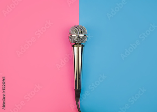 Microphone for karaoke on a pink-blue background.
